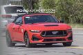 2026 Ford Mustang GT convertible, front three quarters view on public road.