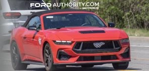 2026 Ford Mustang GT convertible, front three quarters view on public road.