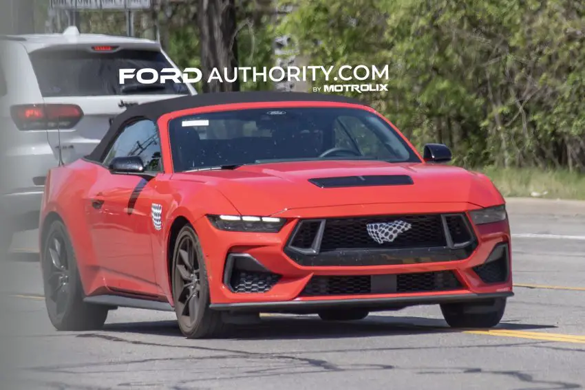 2026 Ford Mustang GT convertible, front three quarters view on public road.