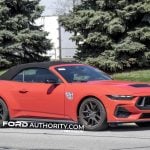 2026 Ford Mustang GT convertible on public road, with its passenger side shown.