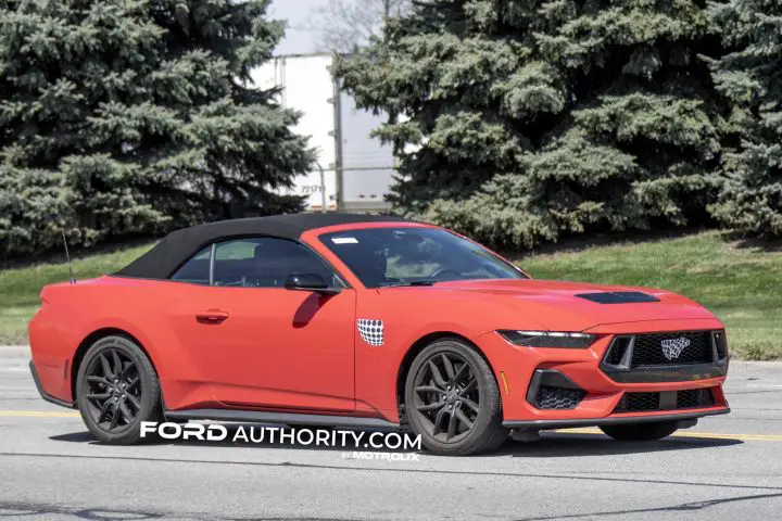 2026 Ford Mustang GT convertible on public road, with its passenger side shown. 