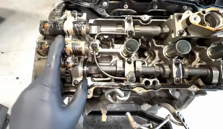 Video still of Brian pointing out a point of failure in the 3.5L V6 EcoBoost engine from the 2015 Ford F-150, caused by a lack of maintenance.