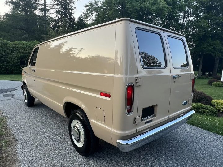 A photo showing the exterior of a 1985 Ford Econoline from a rear three quarters angle.
