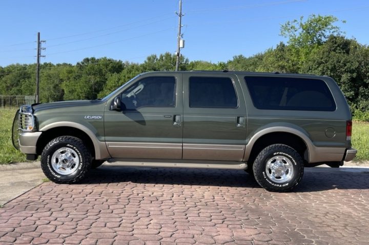Photo showing a side view of the 2003 Ford Excursion currently for sale. The high bid is already well over $50K.