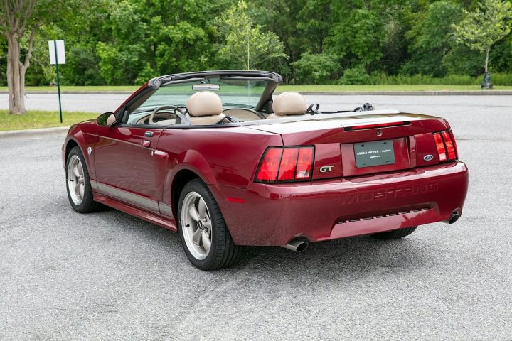 A photo showing the exterior of a 2004 Ford Mustang GT 40th Anniversary Edition convertible from a rear three quarters angle.