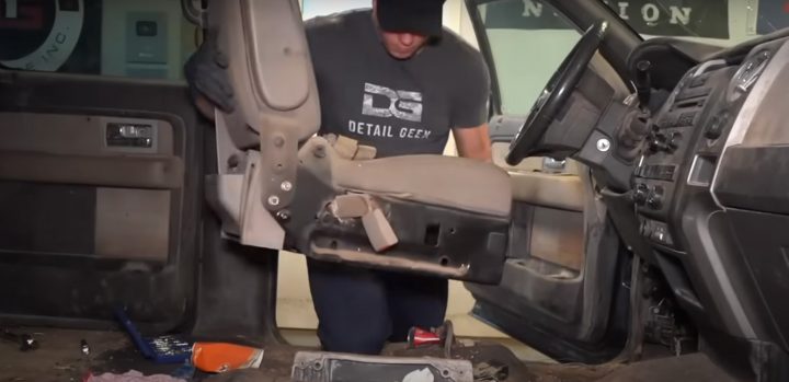 Video still of The Detail Geek removing the seats from the filthy 2010 Ford F-150 so he can clean the interior. It took some work, but he was able to make the pickup shine.