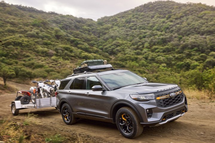 Photo of the 2026 Ford Explorer Tremor, shown from a front three-quarters angle as it tows a trailer. The crossover starts at the $48,000 mark. 