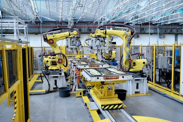 A photo of robots performing automated tasks at the Cologne assembly plant in Germany. The facility is responsible for production of the Ford Explorer and Capri EVs.