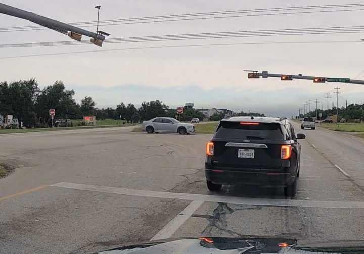 Video still of the Ford Explorer in the intersection before it runs through the red light. 