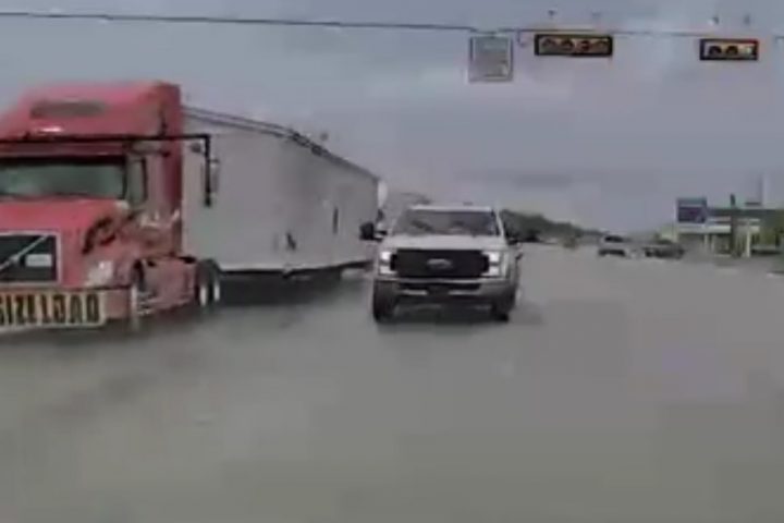 Video still of the Ford Super Duty making a questionable pass through an intersection. It's clear they didn't want to get stuck behind the semi. 