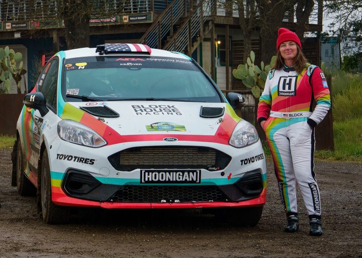 Photo of Lia Block posing with her Ford Fiesta Rally3 race car. She will make her 2025 rally debut this August. 