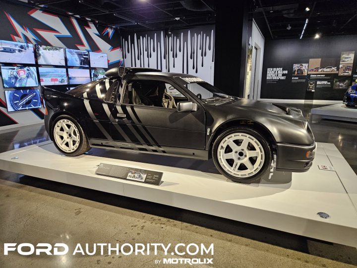 Photo of the 1986 Ford RS200 Evolution owned and customized by Ken Block on display at the Petersen Museum, shown from a front three-quarters angle. 