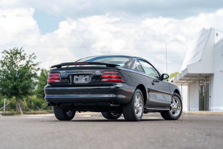A photo showing the exterior of a 1994 Ford Mustang SVT Cobra from a rear three quarters angle.