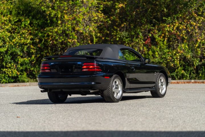 A photo showing the exterior of a 1995 Ford Mustang SVT Cobra from a rear three quarters angle.