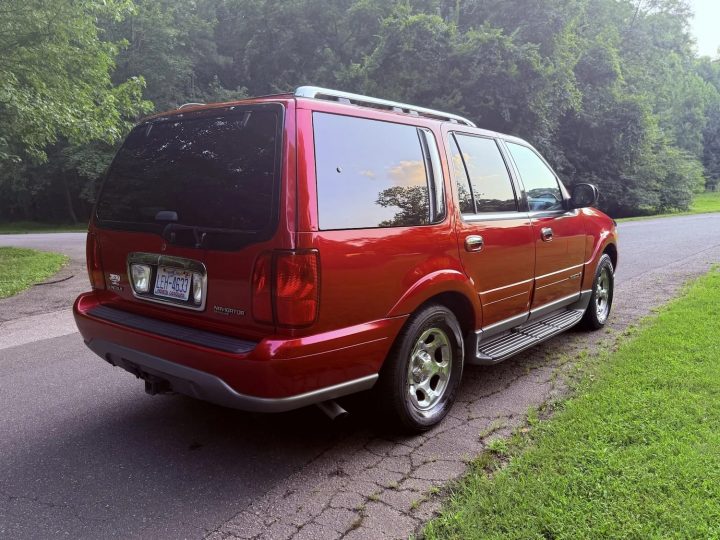 A photo showing the exterior of a 2002 Lincoln Navigator from a rear three quarters angle.