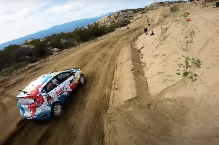 A photo showing the exterior of a 2014 Ford Fiesta ST rally car from a rear three quarters angle.