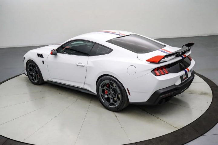 A photo showing the exterior of the 2025 Ford Mustang Dark Horse Spirit of America 810 from a rear three quarters angle.