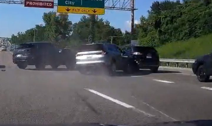 Video still of the Ford Edge as a silver crossover wrecks into it. The Edge was one of three vehicles involved, none of which started the crash. 