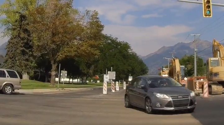 Video screenshot of the Ford Focus diving across the intersection, making an illegal left turn after going the wrong way at an intersection.
