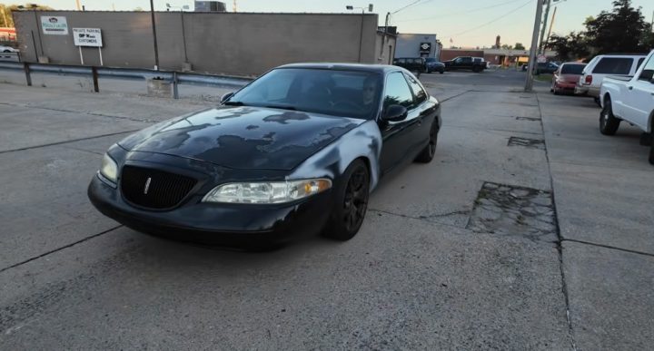 Video still of the Lincoln Mark VIII sleeper car, shown from a front three-quarters angle. It has quite a few suspension mods, but not engine updates.