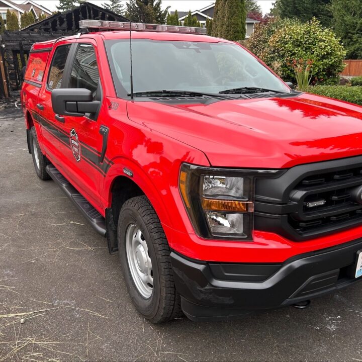 A photo showing the exterior of a South County Fire Department Ford F-150 fire truck from a front three quarters angle.