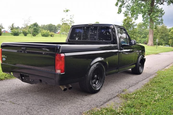 A photo showing the exterior of a 1993 Ford F-150 SVT Lightning from a rear three quarters angle.