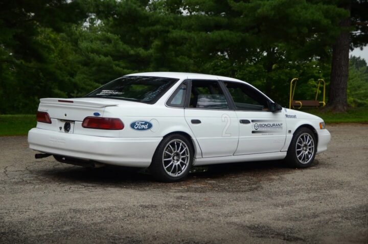 A photo showing the exterior of a 1993 Ford Taurus SHO Bob Bondurant Racing School car from a rear three quarters angle.