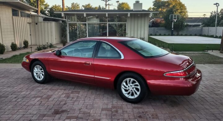 A photo showing the exterior of a 1997 Lincoln Mark VIII from a rear three quarters angle.