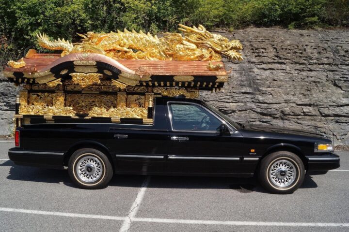 A photo showing the exterior of a 1997 Lincoln Town Car Miyagata hearse conversion from Japan from a side angle.