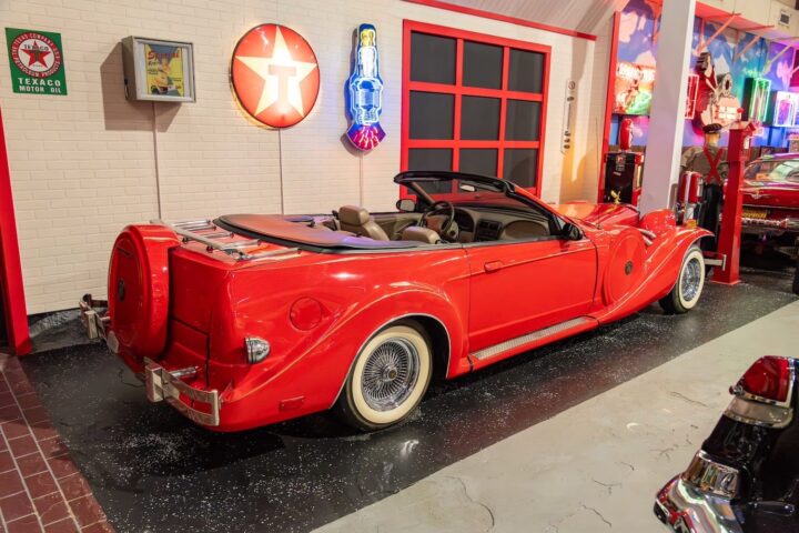 A photo showing the exterior of a 2000 Zimmer Golden Spirit Convertible rebodied Ford Mustang from a rear three quarters angle.