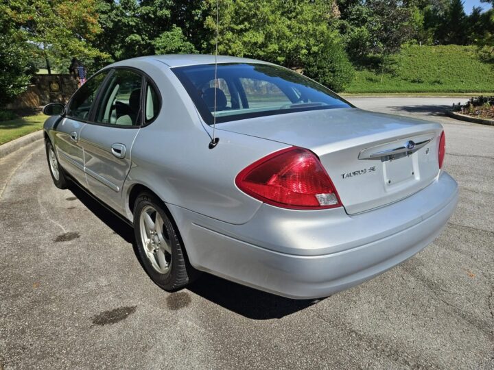A photo showing the exterior of a 2002 Ford Taurus SE from a rear three quarters angle.