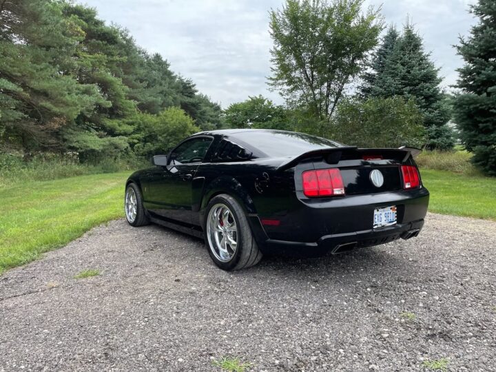 A photo showing the exterior of a 2005 Ford Mustang GT Roush Stage 1 from a rear three quarters angle.