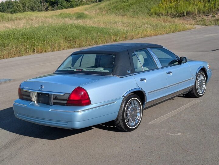 A photo showing the exterior of a 2011 Mercury Grand Marquis from a rear three quarters angle.