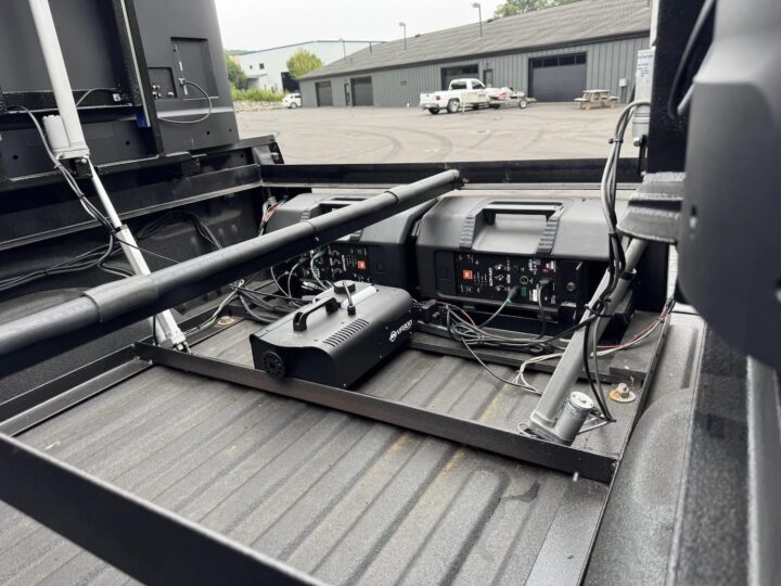 A photo showing a 2017 Ford F-150 bed loaded with an entertainment system.