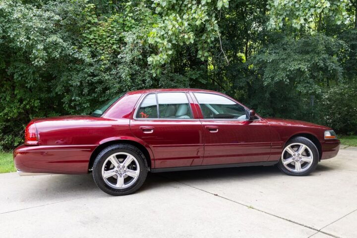 A photo showing the exterior of a Dark Toreador Red 2004 Mercury Marauder from a rear three quarters angle.