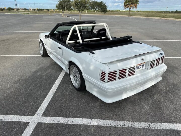 A photo showing the exterior of a 1990 Ford Mustang GT formerly owned by Ken Block from a rear three quarters angle.