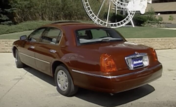 A photo showing the exterior of a 1998 Lincoln Town Car from a rear three quarters angle.