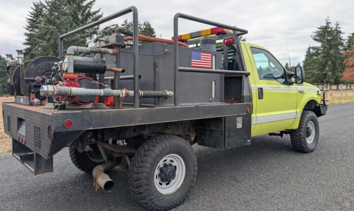 A photo showing the exterior of a 1999 Ford F-350 Super Duty brush fire truck from a rear three quarters angle.
