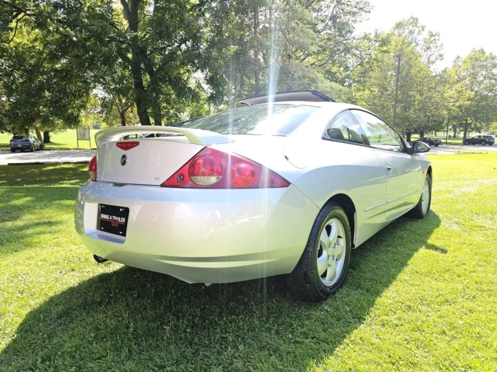 A photo showing the exterior of a 2000 Mercury Cougar from a rear three quarters angle.