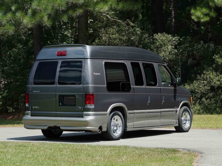 A photo showing the exterior of a 2004 Ford E-150 conversion van from a rear three quarters angle.
