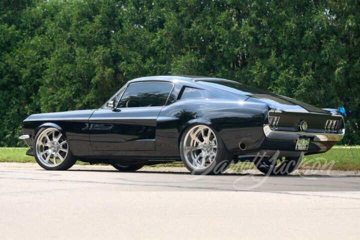A photo showing the exterior of a carbon fiber 1968 Ford Mustang from a rear three quarters angle.