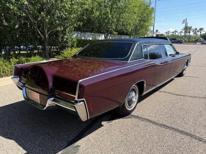A photo showing the exterior of a 1969 Lincoln Continental limo from a rear three quarters angle.