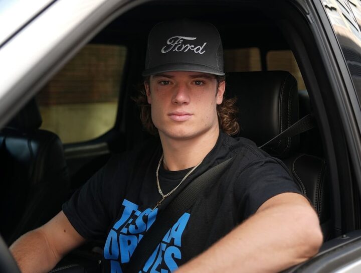 A photo of Detroit Lions wide receiver Isaac TeSlaa in a Ford F-150 Lightning.