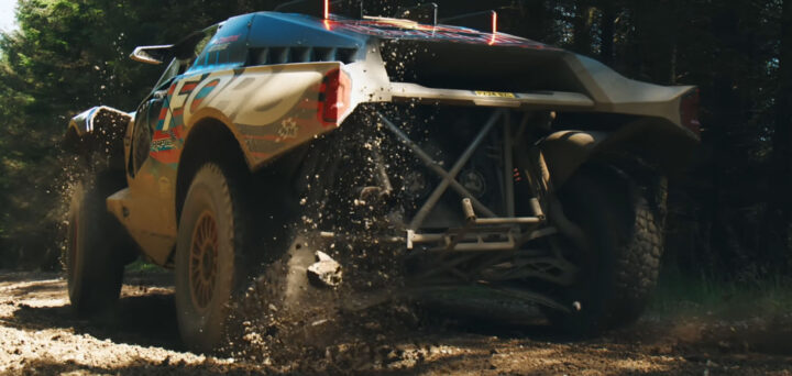 Video still of the Ford Raptor T1+ driving off-road in a test against the Ariel Nomad 2. 