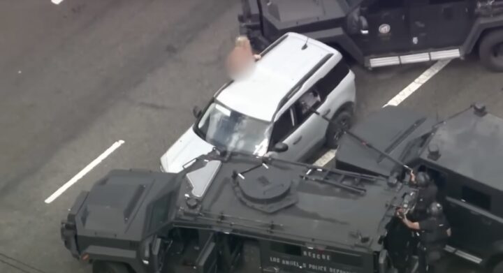 A photo showing a Ford Bronco Sport and its naked driver being arrested from a front three quarters angle.