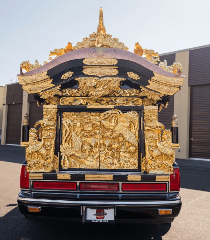 A photo showing the exterior of a 1997 Lincoln Town Car Miyagata Hearse from a rear angle.