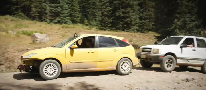 Video still of the 2004 Ford Focus SVT getting a push from its competitor in Donut's cheap car challenge.