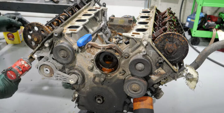Photo of the Ford 4.6L V8 engine on the engine stand, partially disassembled. The engine suffered abuse and lack of maintenance during its lifetime, resulting in total failure. 