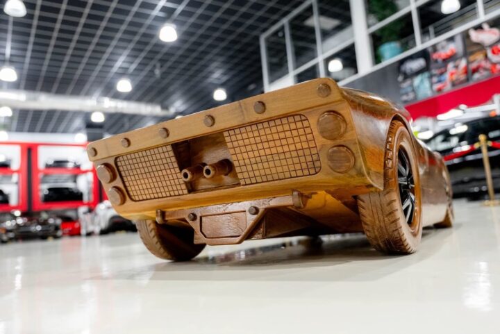 A photo showing the exterior of a Ford GT40 wooden display model from a rear three quarters angle.