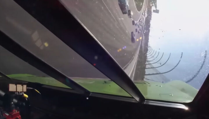 Video still captured from in-car footage of Zane Smith's wreck, showing his NASCAR Ford on its side against the wall. The race car held up under the strange crash.